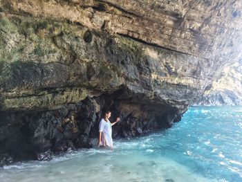 Woman standing on rocks at beach