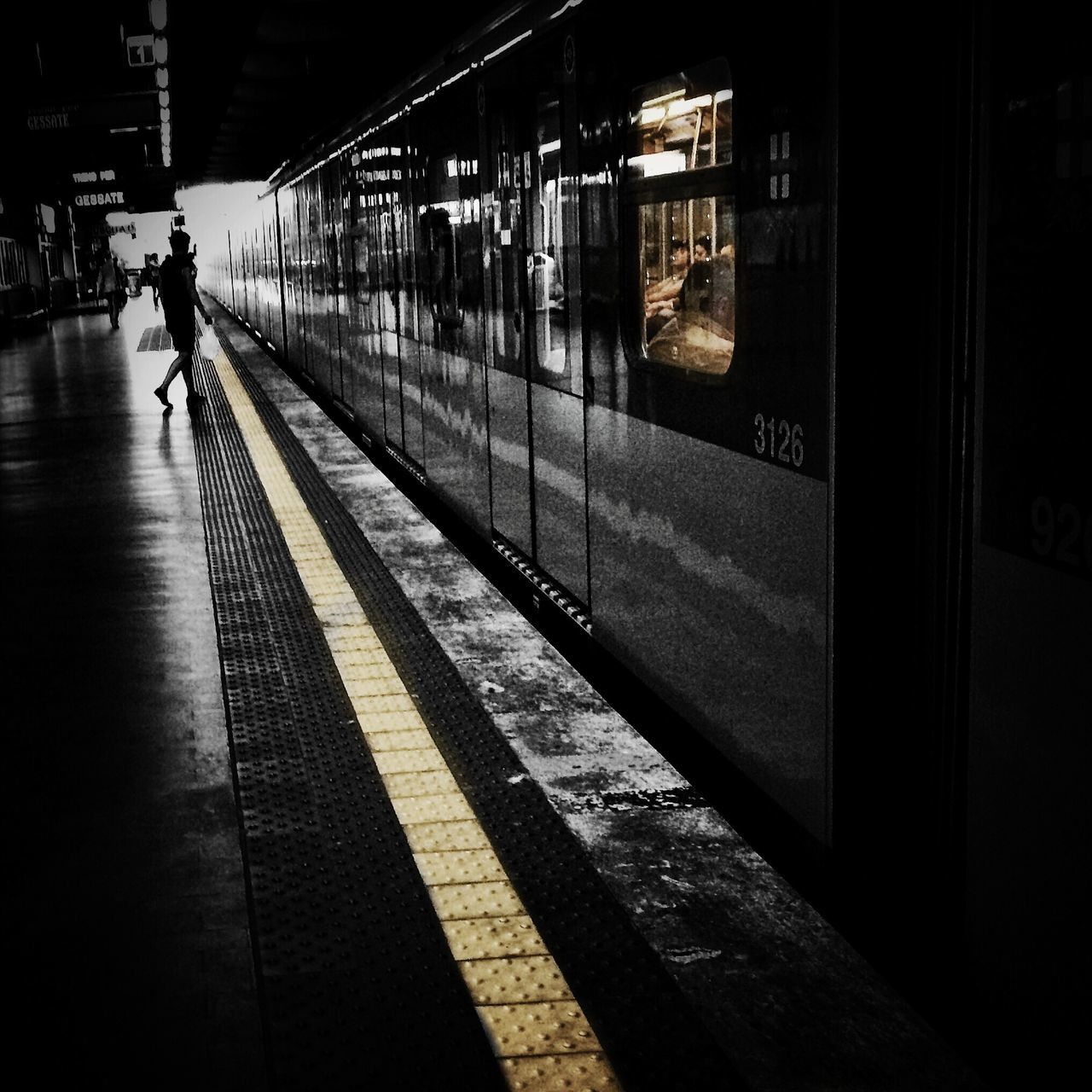 men, walking, lifestyles, architecture, built structure, night, illuminated, full length, city life, transportation, person, railroad station platform, building exterior, public transportation, railroad station, city, rear view, leisure activity