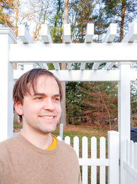 Portrait of smiling woman standing against plants