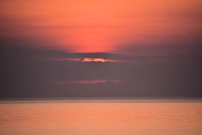 Scenic view of sea against orange sky