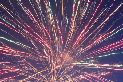 Low angle view of firework display at night