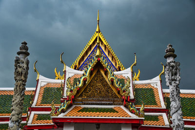 Statue of temple against building