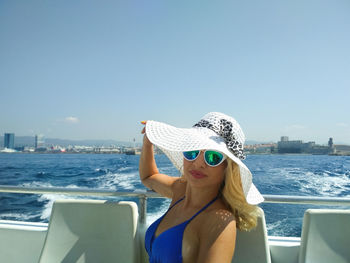 Portrait of beautiful woman in sea against sky