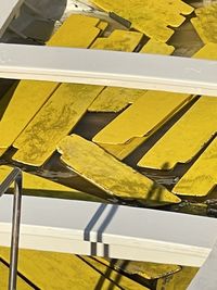 High angle view of yellow umbrella on railing