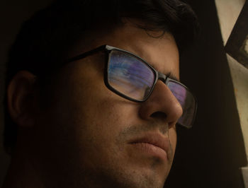 Close-up portrait of young man looking away