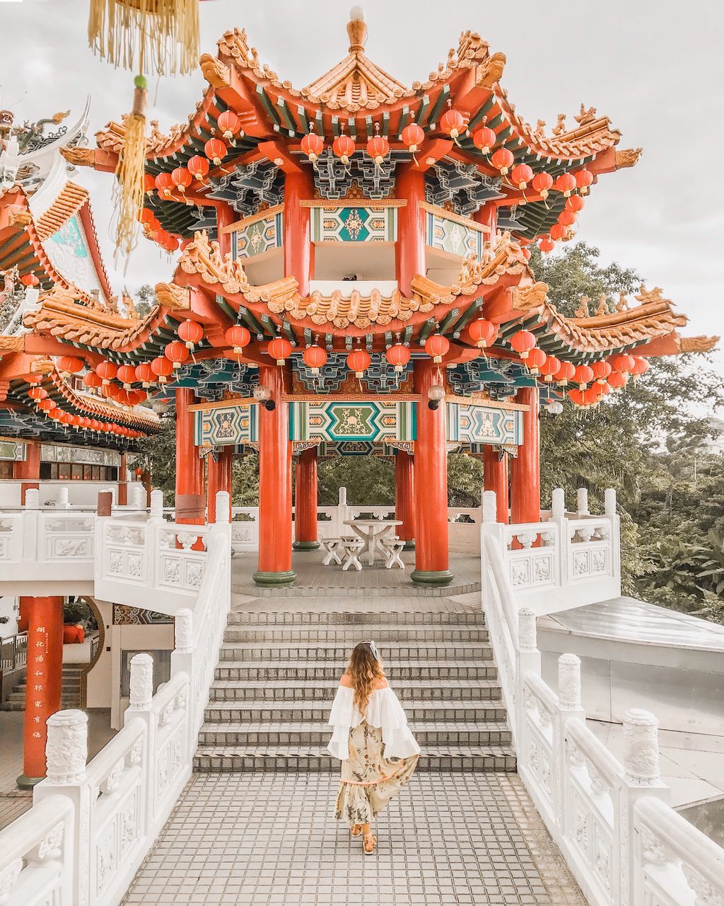 LOW ANGLE VIEW OF WOMAN OUTSIDE BUILDING