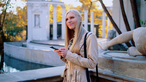 Portrait of young woman using mobile phone