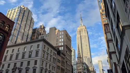 Low angle view of the empire state building against sky in new york city.