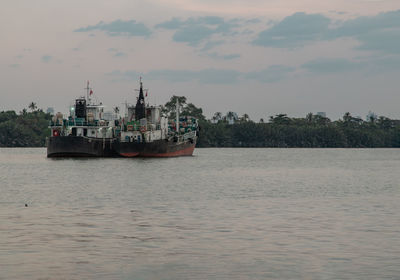 Ship sailing on sea against sky