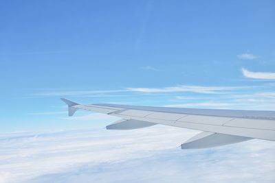 Airplane wing against sky