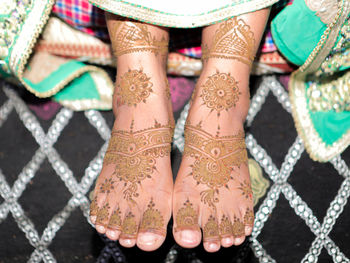 Low section of woman standing on tiled floor