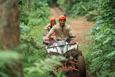 Rear view of man standing in forest