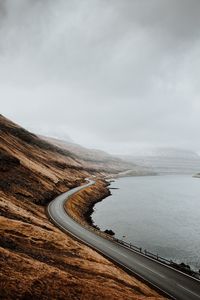 Scenic view of road by land against sky