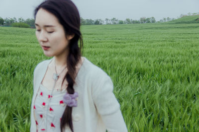 Young woman standing on field