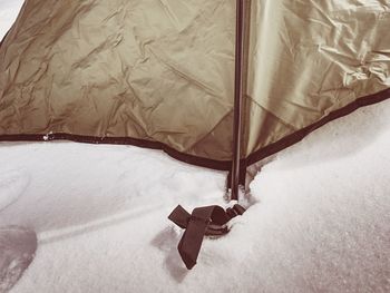 Detail of tent anchorage on snow. a snow storm came within night and cover with fresh powder snow.