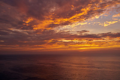 Scenic view of sea against romantic sky at sunset