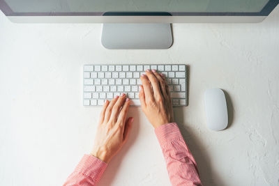 Low angle view of hand using laptop on table