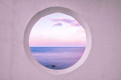 Scenic view of sea against sky seen through window