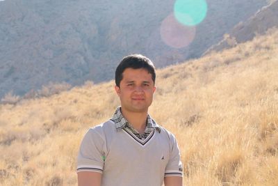 Portrait of young man standing on land