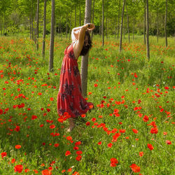 Woman with arms raised on field