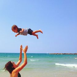 Woman jumping in sea