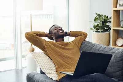 Man sitting on sofa at home