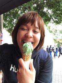 Portrait of smiling woman holding ice cream