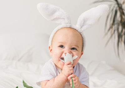 Cute baby boy sleeping on bed at home