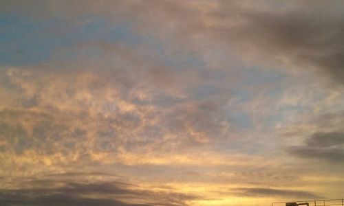 Low angle view of cloudy sky at sunset