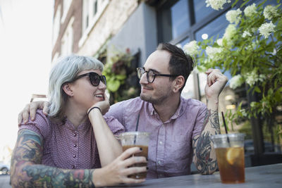 Young couple sitting with drink