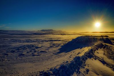 Scenic view of sea against clear sky during winter