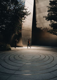 People walking on footpath in city