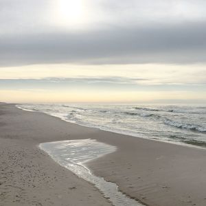 Scenic view of beach against sky during sunset