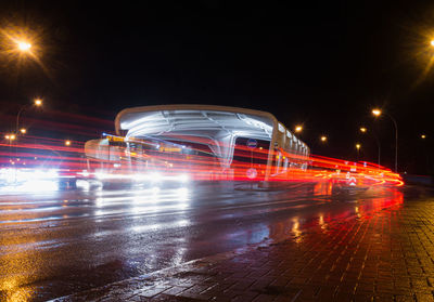 Light trails on city street during rainy season at night