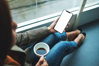 Midsection of woman using mobile phone