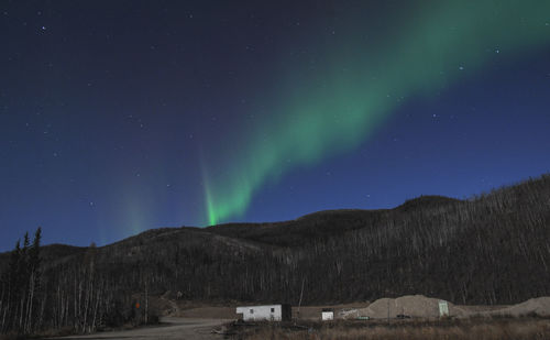 Scenic view of mountains against sky at night