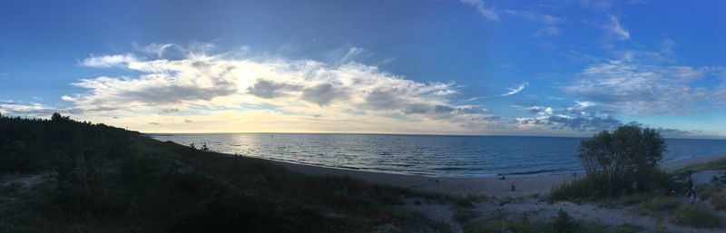 View of calm beach against blue sky