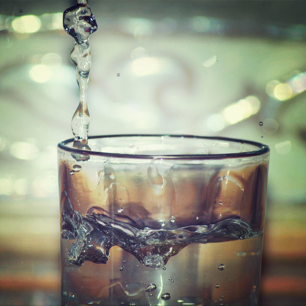 indoors, close-up, focus on foreground, transparent, glass - material, water, drinking glass, refreshment, drop, drink, table, still life, food and drink, reflection, glass, selective focus, bubble, liquid, purity, freshness