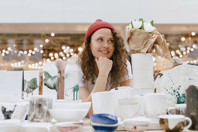 Girl selling handmade ceramics market counter