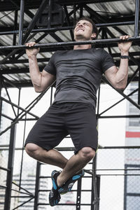 Man training at rooftop gym in bangkok