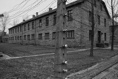 Old building by street in city