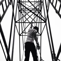 Low angle view of man standing against sky