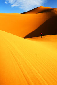 Sunlight falling on desert against sky