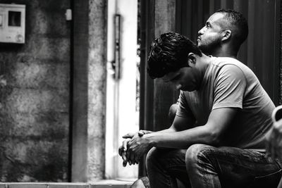 Thoughtful friends sitting in room