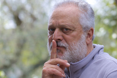 Portrait of man holding camera outdoors