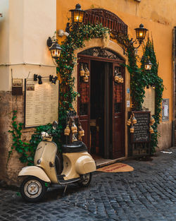 Motor scooter on street against building