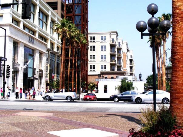 CARS ON ROAD AGAINST BUILDINGS