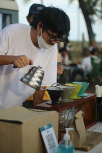 Rear view of man working on table