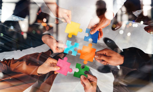 High angle view of people playing jigsaw puzzle