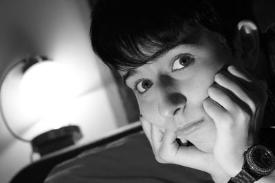 Close-up portrait of young woman at home